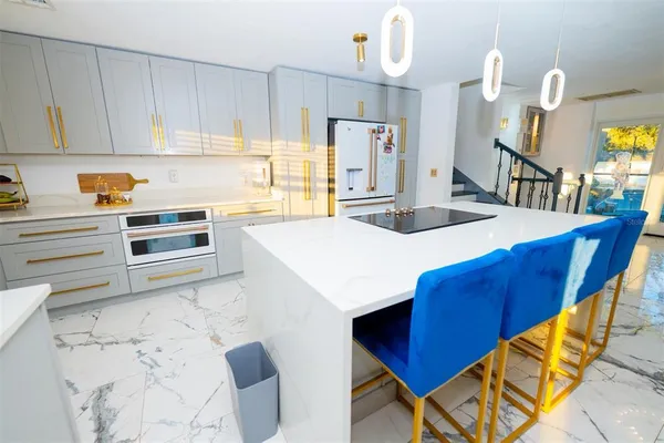 a view of a dining room with furniture a chandelier and wooden floor