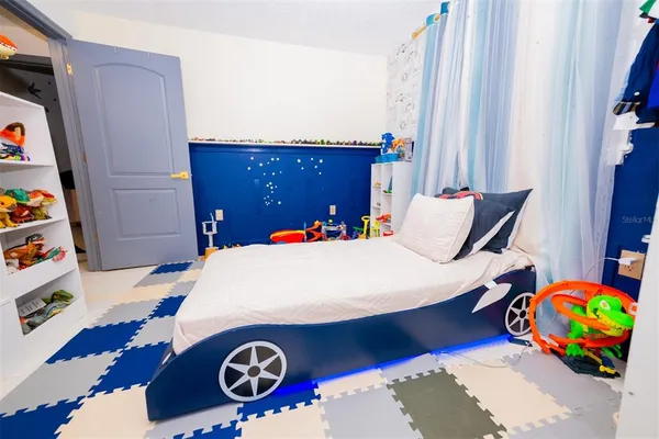 a bedroom with a bed and dresser