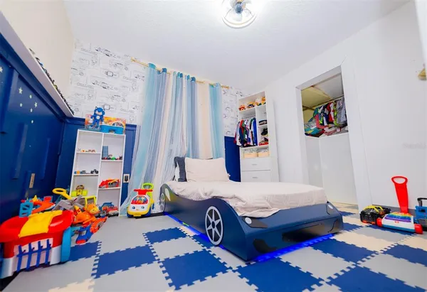 a view of walk in closet with clothes