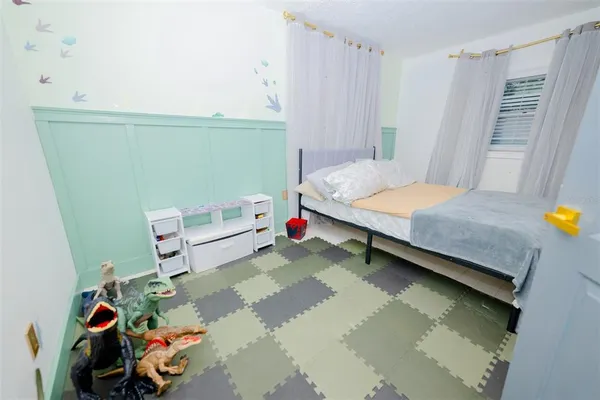 a bedroom with a bed and a window