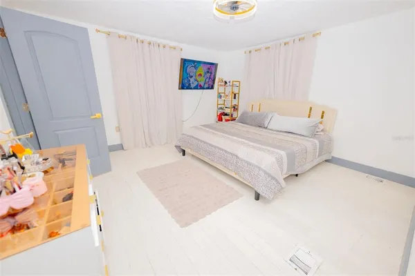 a bedroom with a bed and a dresser