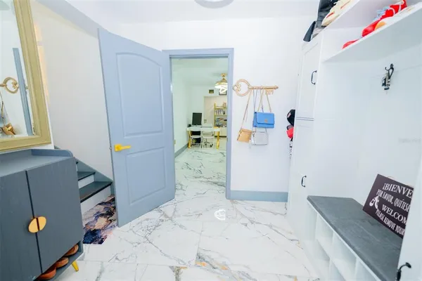 a living room with furniture and a kitchen