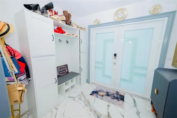 a view of a hallway with workspace and a window