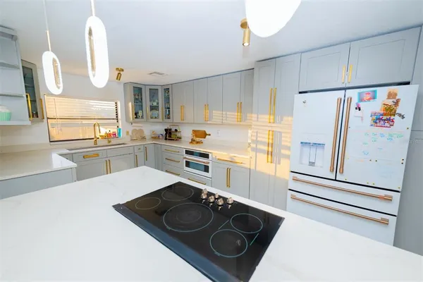 a kitchen with a refrigerator stove and sink