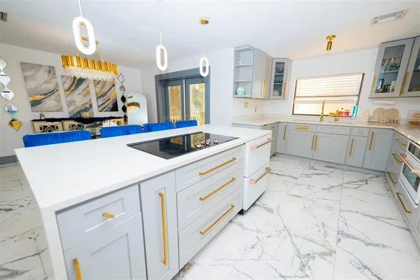 a kitchen that has a sink and a stove