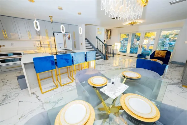 a view of a dining room with furniture a rug and wooden floor