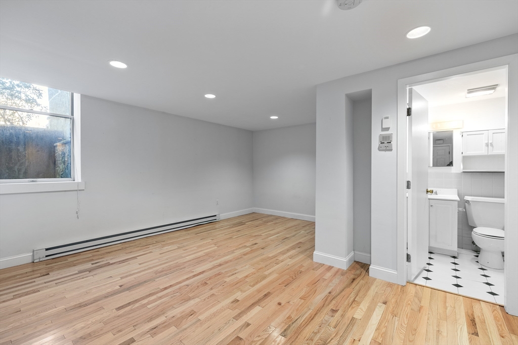 1763 Beacon Street, Unit A Brookline, MA 02445 - Photo 14 of 20 a view of empty room with wooden floor