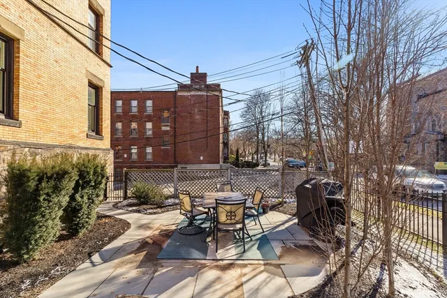a view of a patio with table and chairs and potted plants