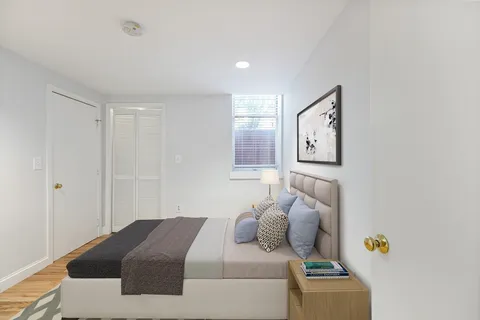 a bedroom with a bed and a window