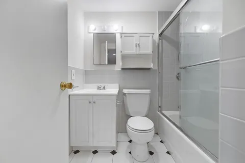 a bathroom with a toilet sink and shower