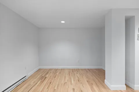 a view of room with window and wooden floor