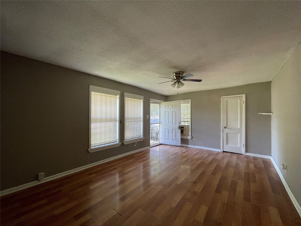 4623 Perry Street Houston, TX 77021 - Photo 3 of 9 a view of an empty room with wooden floor and a window