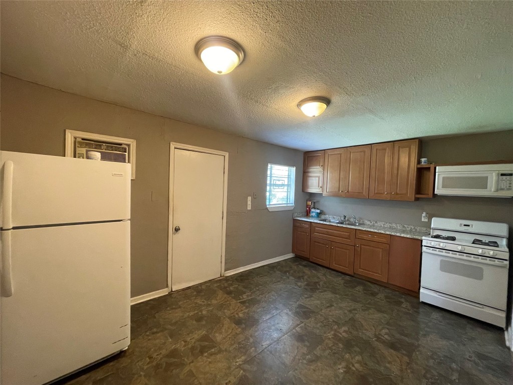4623 Perry Street Houston, TX 77021 - Photo 5 of 9 a kitchen with stainless steel appliances granite countertop a refrigerator a stove and a sink