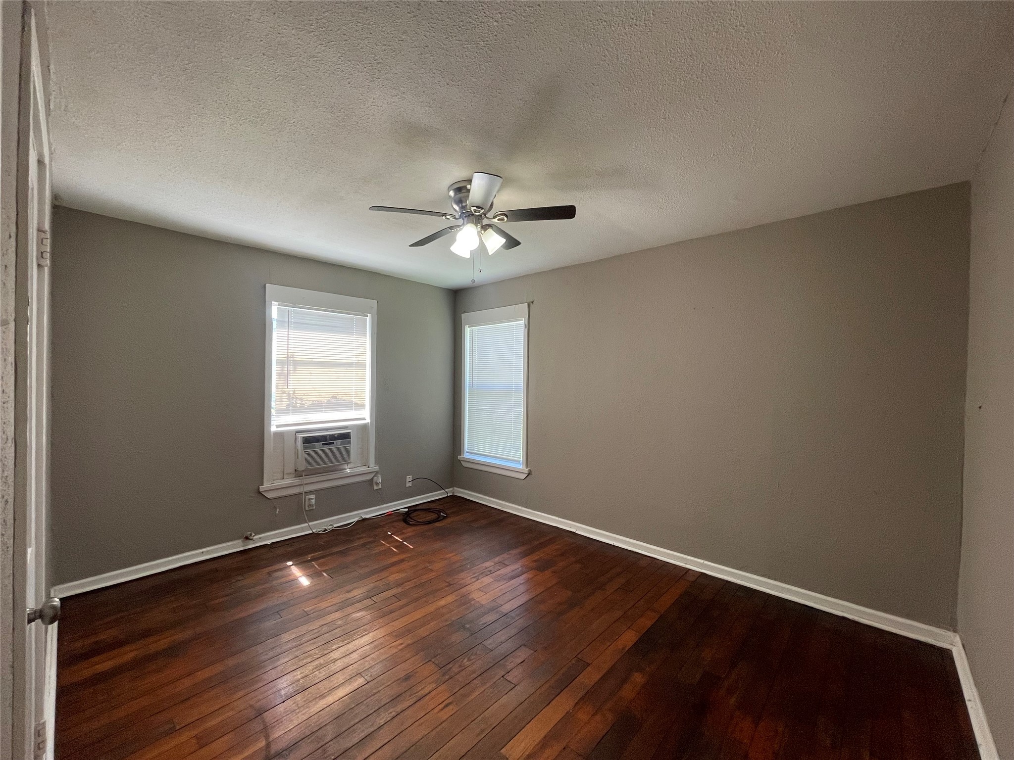 4623 Perry Street Houston, TX 77021 - Photo 8 of 9 an empty room with wooden floor and windows