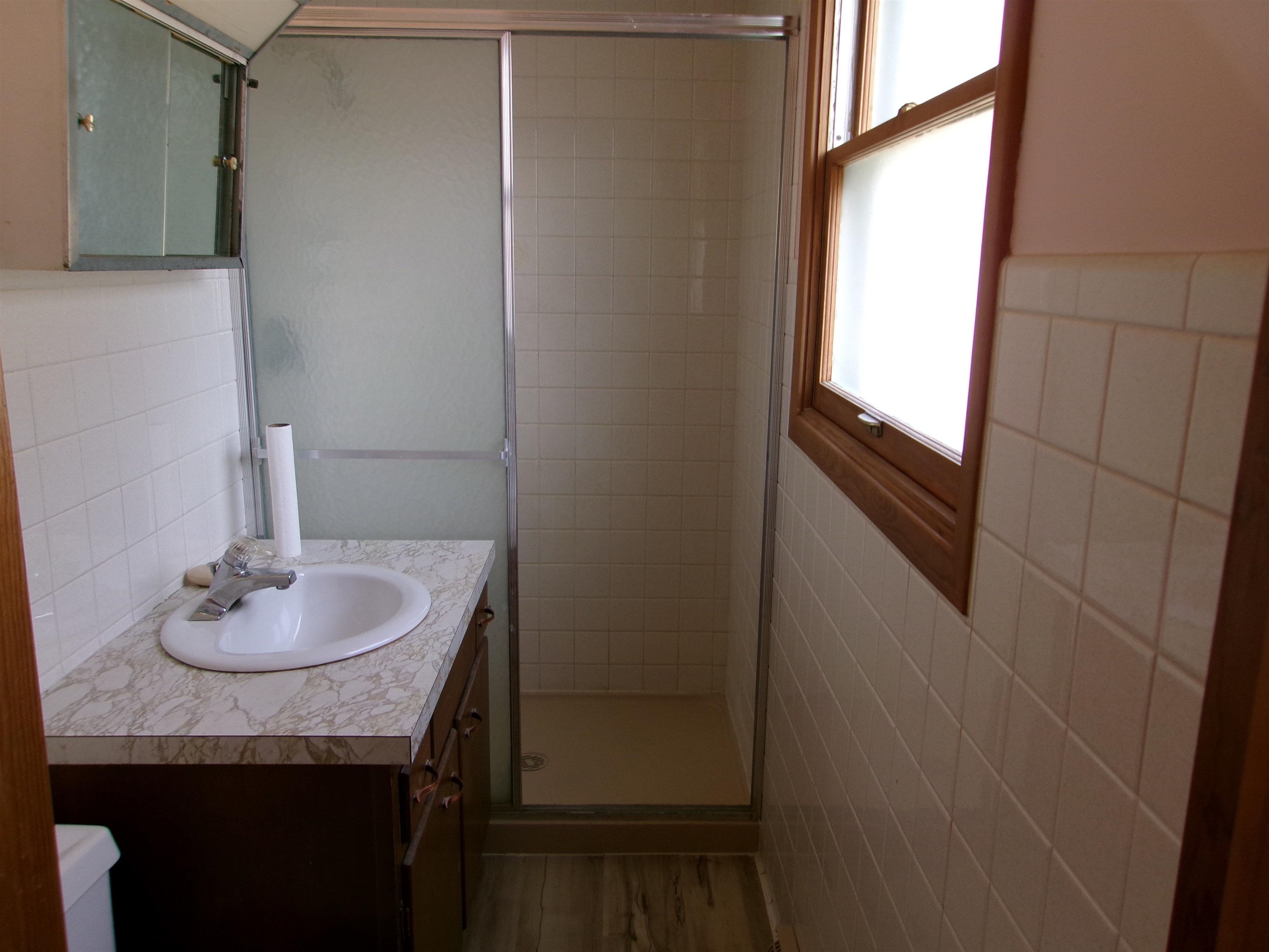 2517 Rock Street Peru, IL 61354 - Photo 9 of 12 a bathroom with a granite countertop sink and a mirror