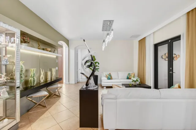 a living room with lots of furniture and view of kitchen