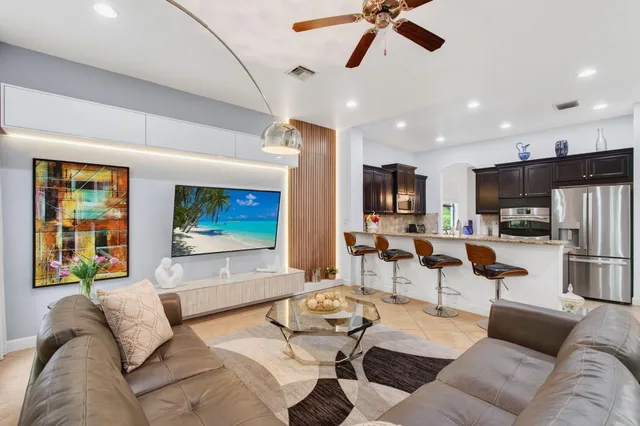 a spacious bathroom with a granite countertop double vanity sink a mirror and a bathtub