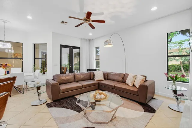 a spacious bathroom with a tub sink and mirror