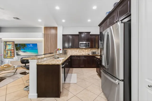 a view of a livingroom with furniture and floor to ceiling window