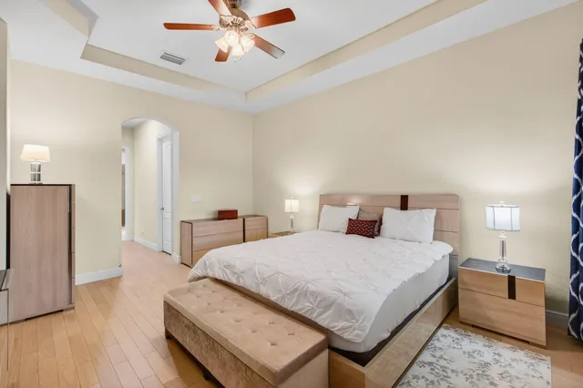 a kitchen with white cabinets and a refrigerator