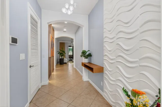a dining room with wooden floor a chandelier a wooden table and chairs