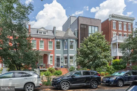 a front view of a house with parking space