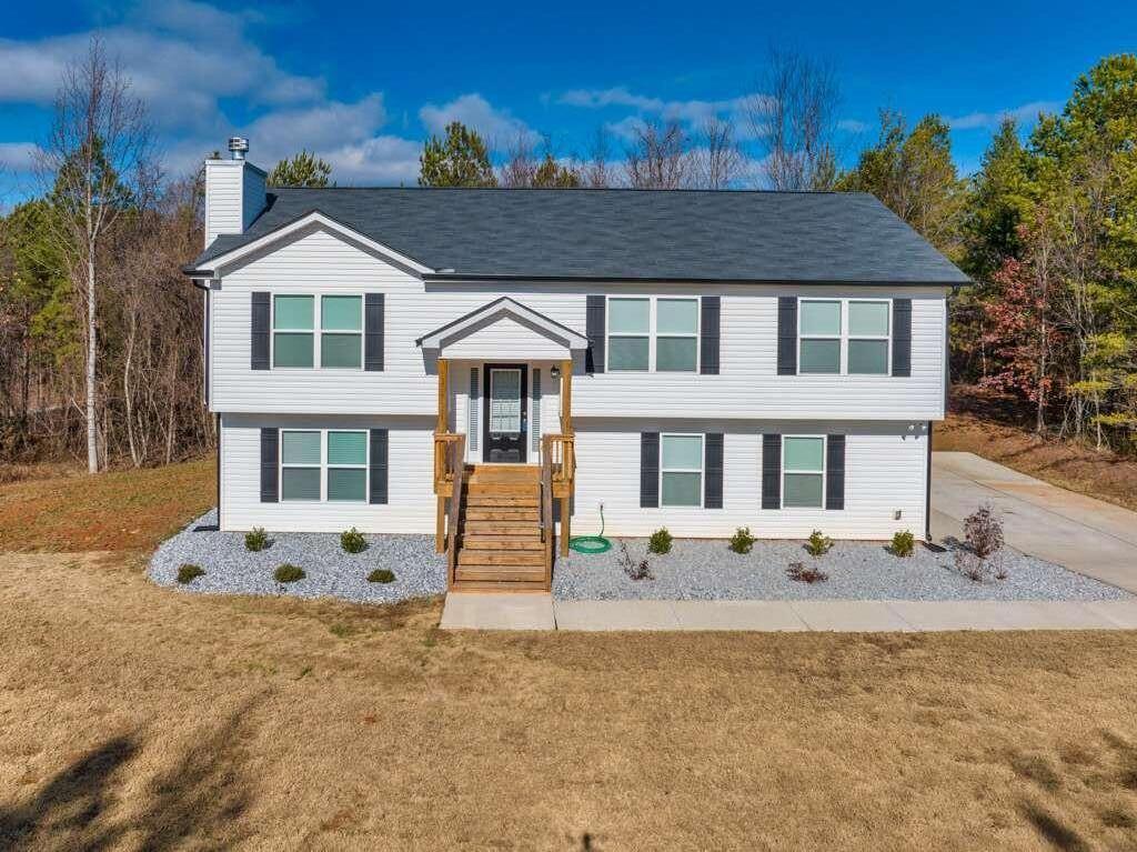 718 Signature Dr Mount Mount Airy, GA 30563 - Photo 1 of 1 a front view of a house with a yard
