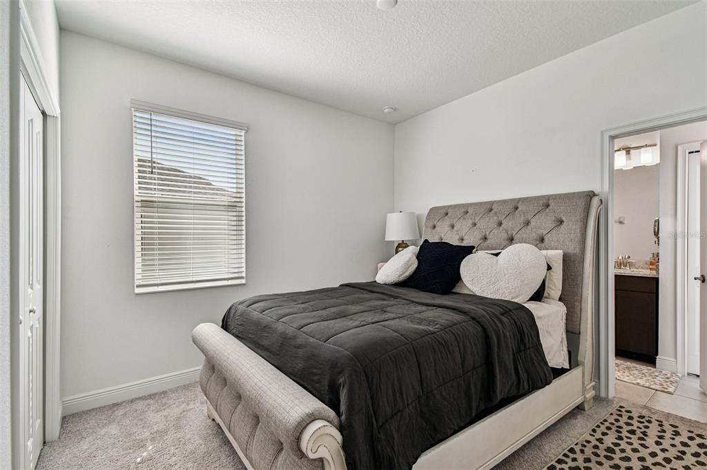 1039 Davis Heather Circle Seffner, FL 33584 - Photo 12 of 27 a bedroom with a bed and wooden floor