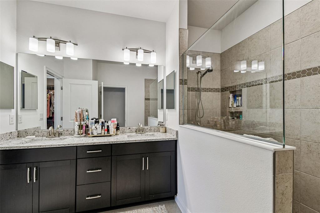 1039 Davis Heather Circle Seffner, FL 33584 - Photo 18 of 27 a bathroom with a sink vanity and a mirror