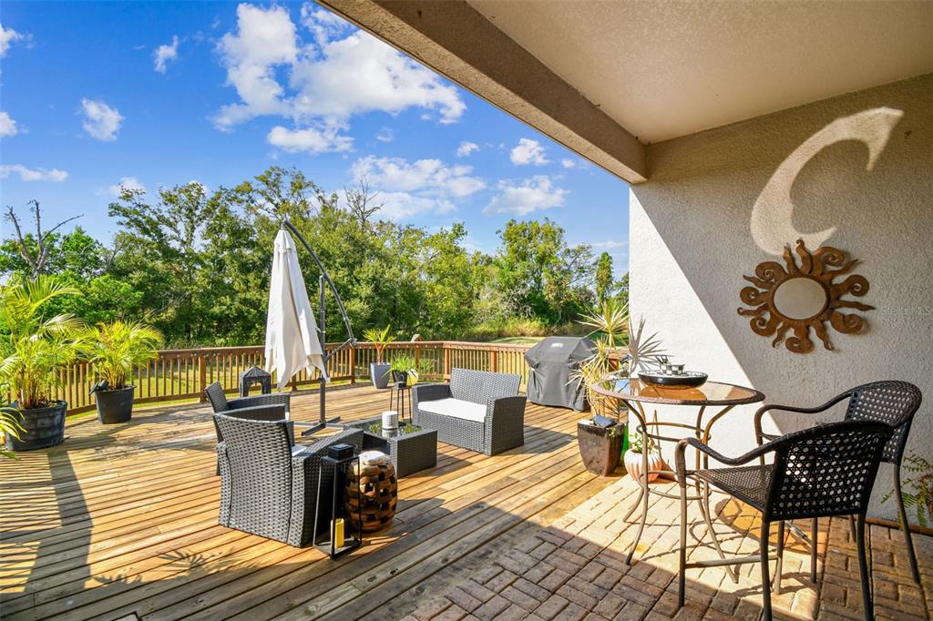 1039 Davis Heather Circle Seffner, FL 33584 - Photo 21 of 27 a view of a patio with table and chairs and wooden floor