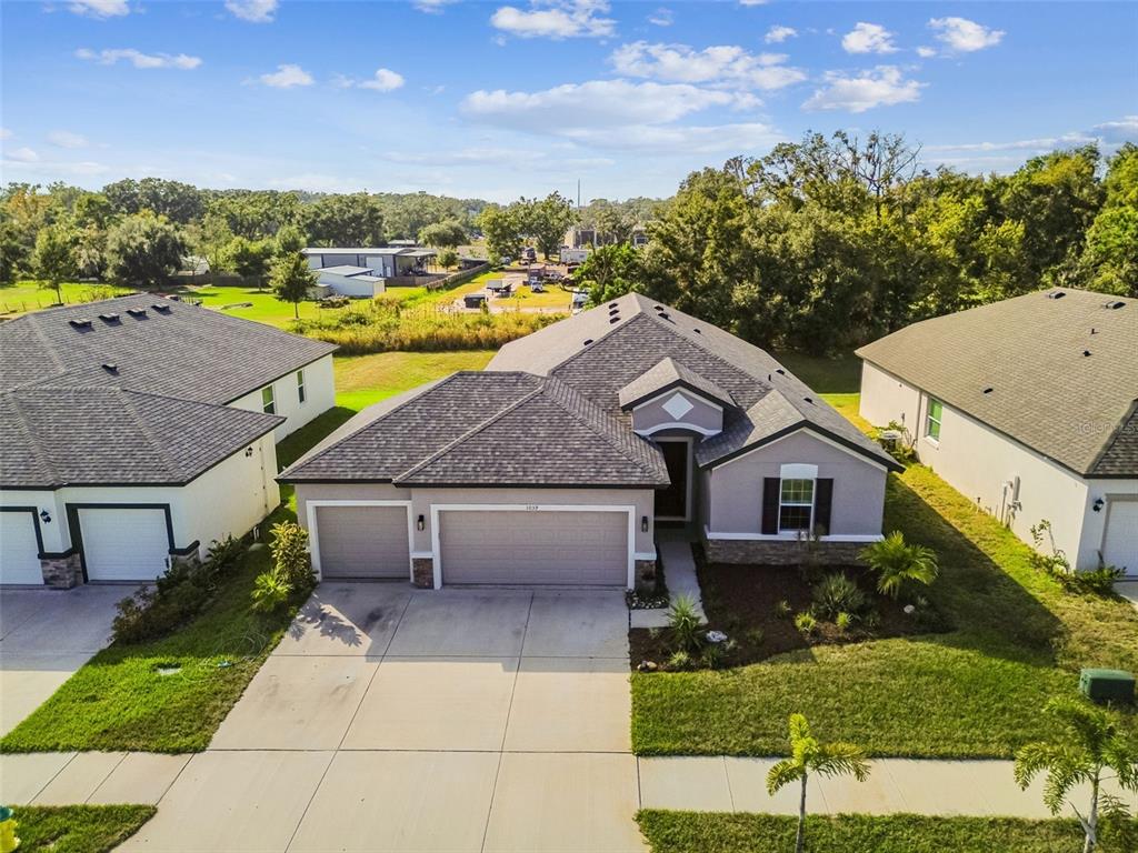 1039 Davis Heather Circle Seffner, FL 33584 - Photo 25 of 27 a aerial view of a house with a yard table and chairs