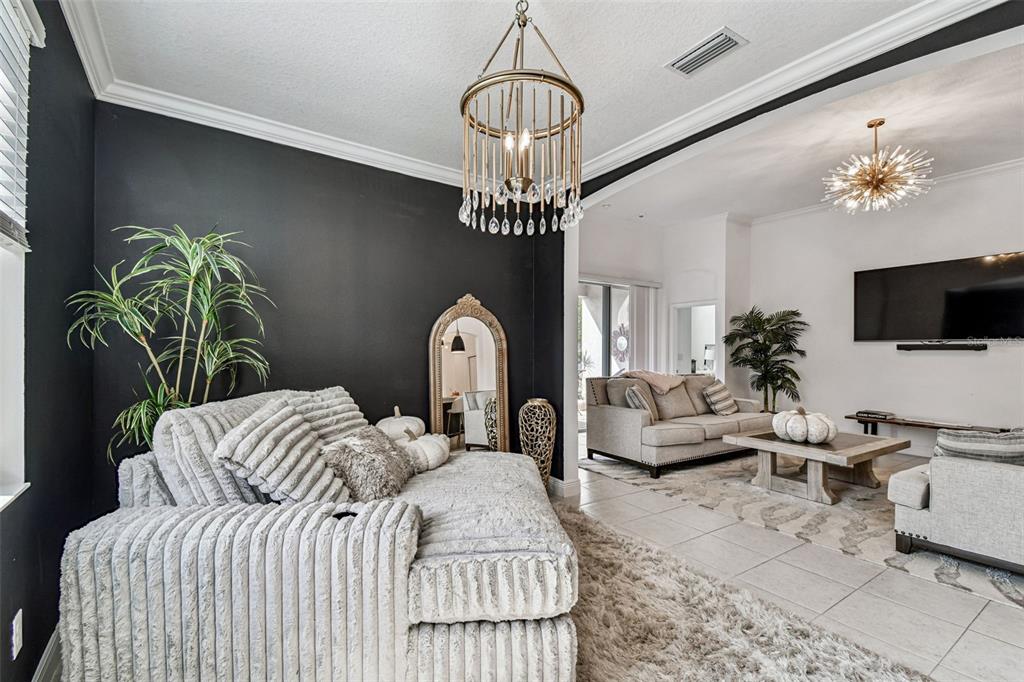 1039 Davis Heather Circle Seffner, FL 33584 - Photo 8 of 27 a bedroom with a bed couch chandelier and a potted plant