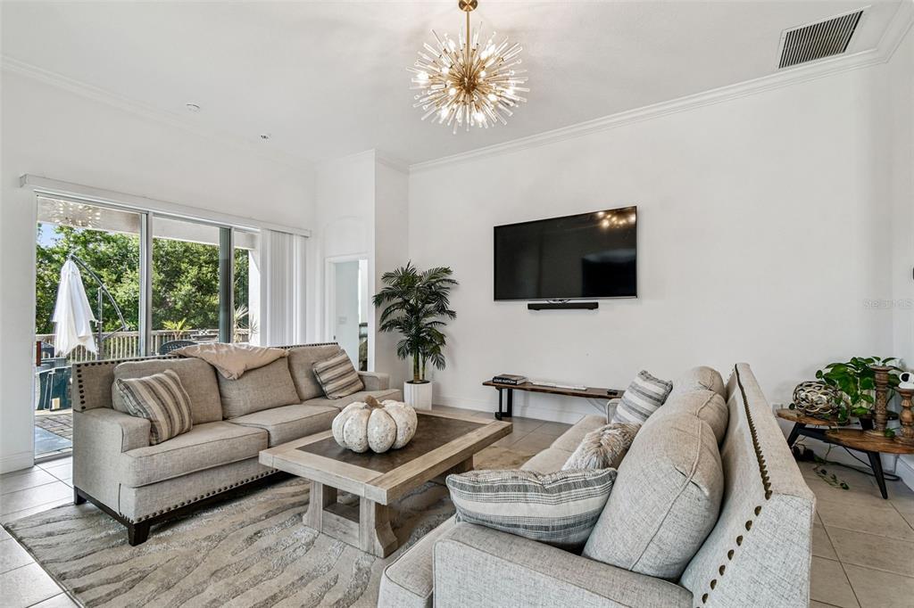 1039 Davis Heather Circle Seffner, FL 33584 - Photo 9 of 27 a living room with furniture a flat screen tv and a large window