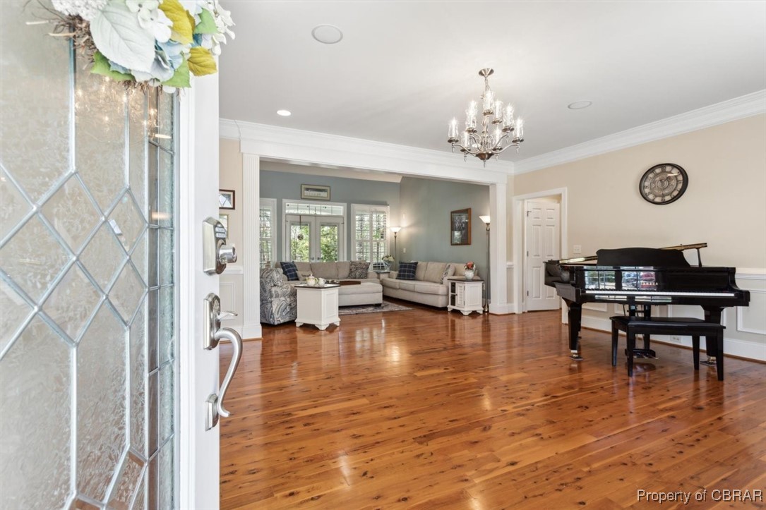 3013 Ridge Drive Toano, VA 23168 - Photo 5 of 50 Entrance foyer featuring wood finished floors, a notable chandelier, and ornamental molding