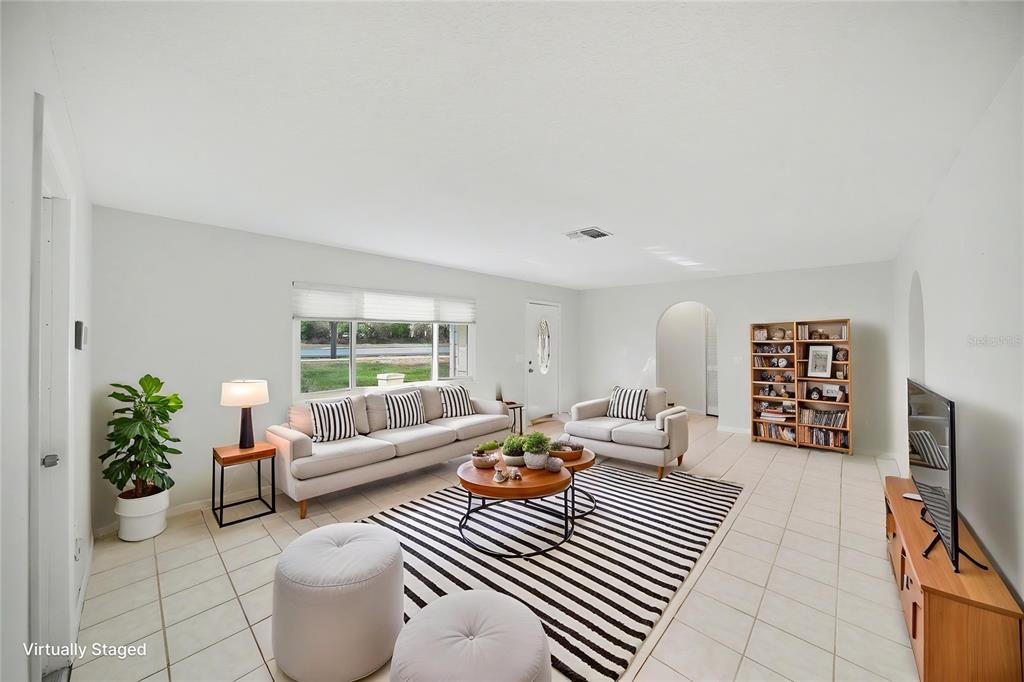 113 Ruskin Avenue Spring Hill, FL 34606 - Photo 5 of 32 a living room with furniture and a flat screen tv