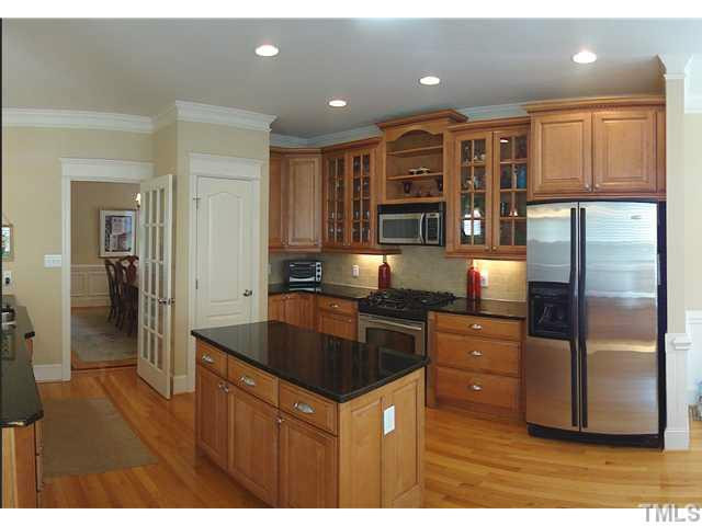 Bright open kitchen with 42in cabinetry, tile backsplash, stainless appliances, center island, gas range and overhead microwave. Kitchen