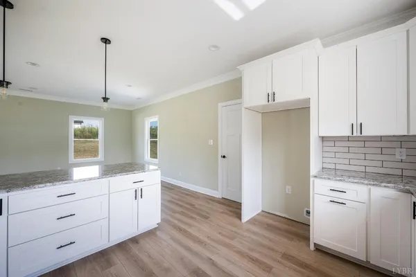a kitchen with white cabinets and white appliances