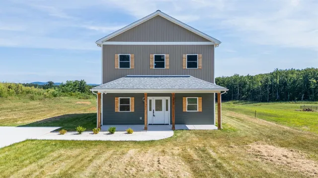 a view of a house with pool and yard