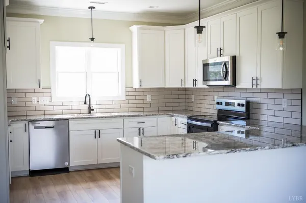 a bathroom with a granite countertop sink a mirror and shower