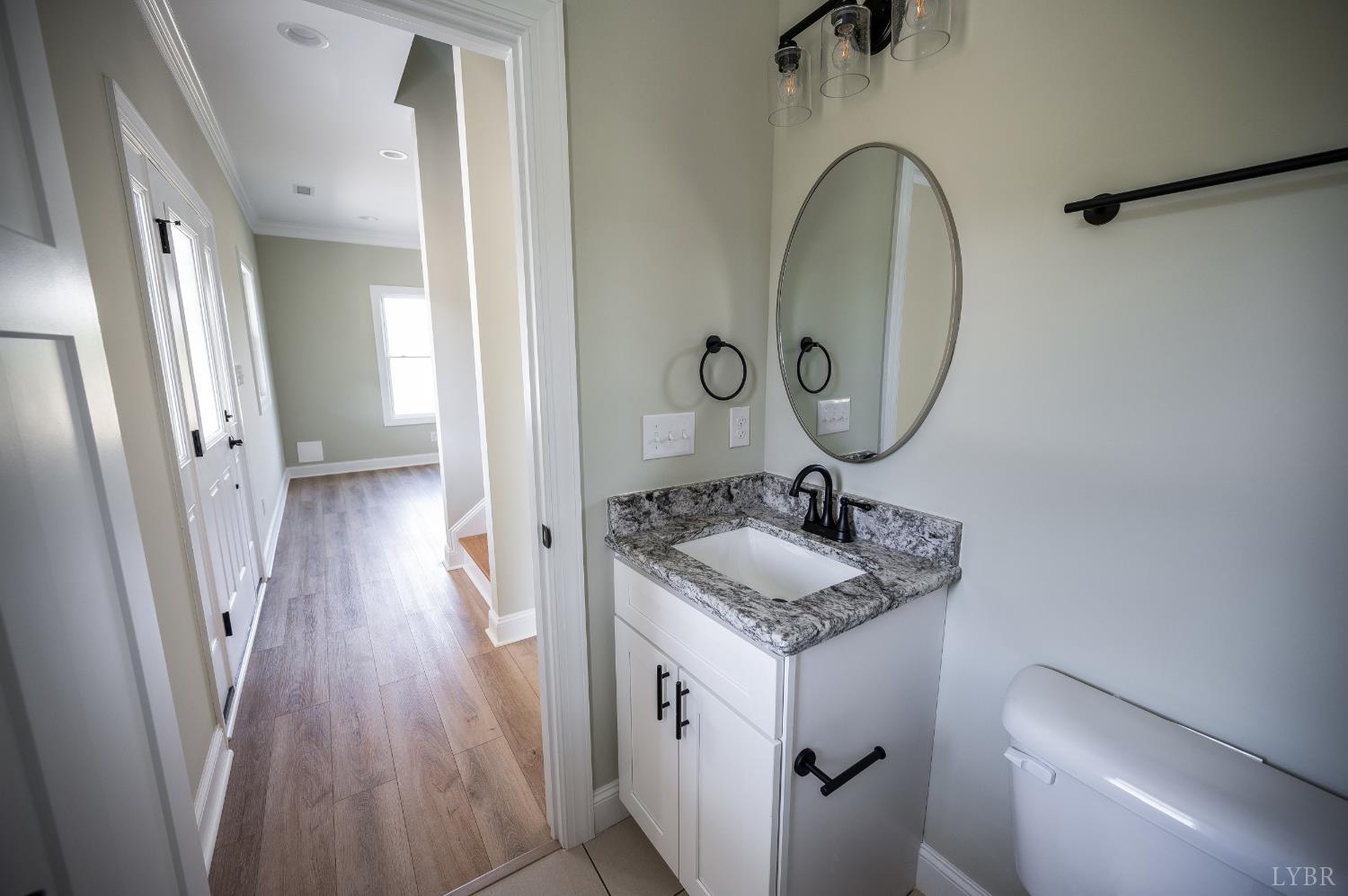 272 Marshall Mill Road Gladys, VA 24554 - Photo 28 of 71 a bathroom with a granite countertop sink a mirror and shower