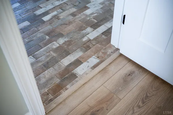 a view of a swimming pool and lounge chairs in back yard