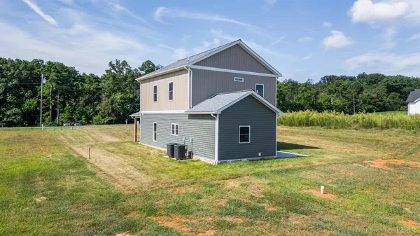 a view of room with wooden floor and ceiling fan