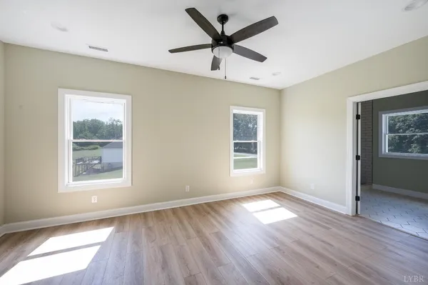 a bathroom with a granite countertop sink toilet and a mirror
