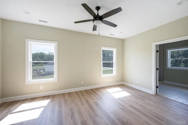 a bathroom with a granite countertop sink toilet and a mirror