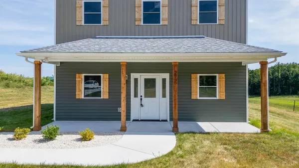 a view of house with backyard
