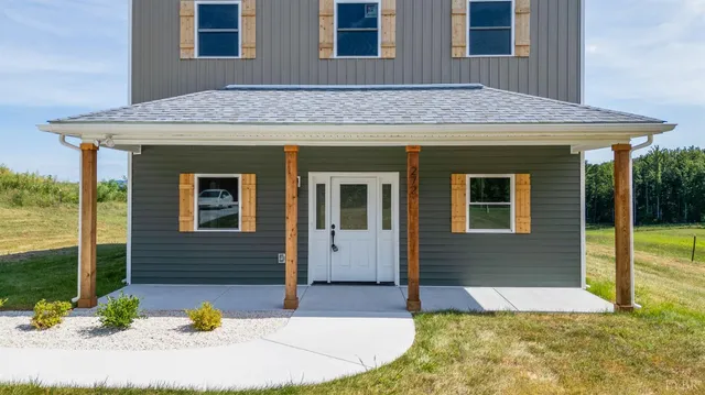 a view of house with backyard