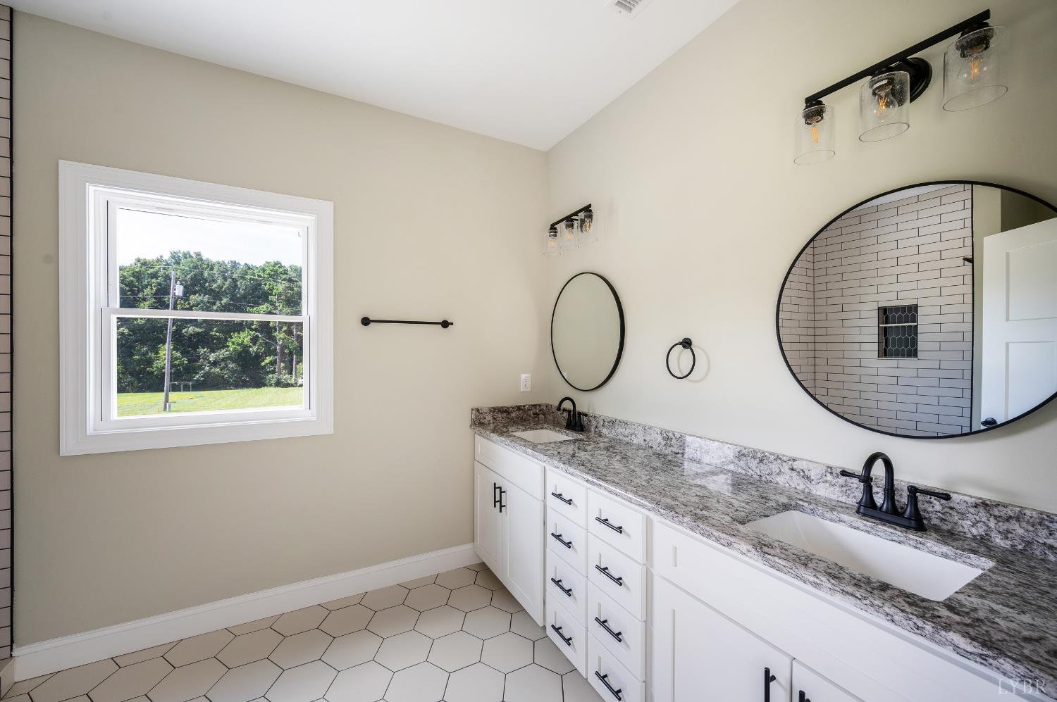 272 Marshall Mill Road Gladys, VA 24554 - Photo 52 of 71 a bathroom with a granite countertop sink mirror and vanity
