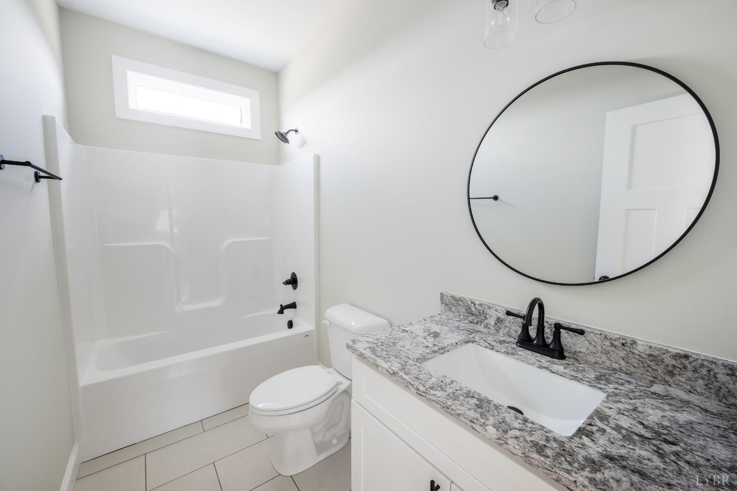 272 Marshall Mill Road Gladys, VA 24554 - Photo 69 of 71 a bathroom with a granite countertop sink toilet and a mirror