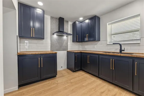 a kitchen with stainless steel appliances granite countertop wooden cabinets and a sink