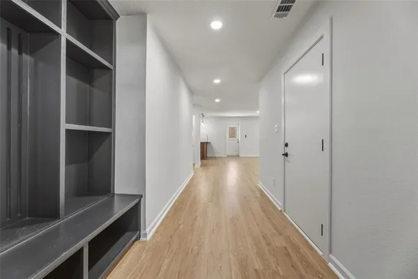 a view of hallway with wooden floor